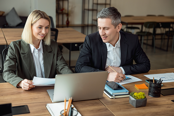 Two lawyers working together on a a laptop in the office