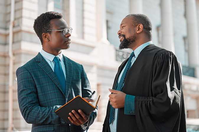 Young lawyer talking with a judge outside