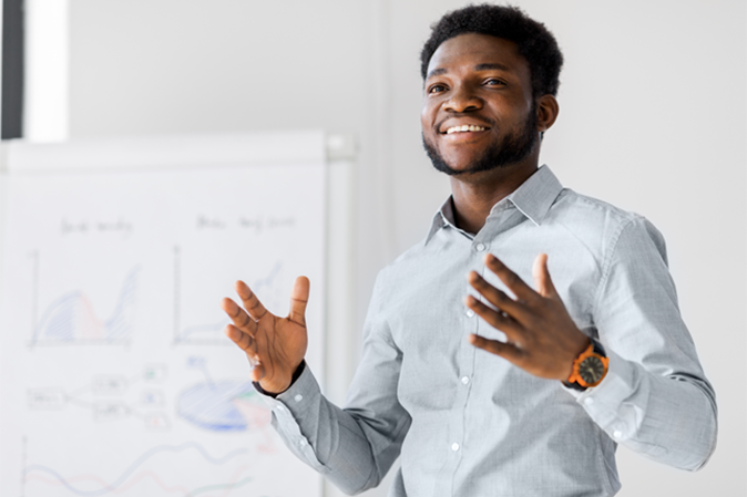 Young man presenting in front of a classroom